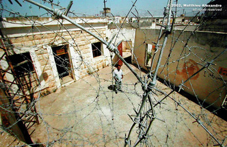 Picture of a tour guide at a former prison in Kyam, Lebanon.  The guard was previously held and tortured in this same prison years previously.  © 2002, Matthieu Alexandre; part of FreePhotoCourse.com's “Photographer Profiles” series; DO NOT COPY – IP Address recorded - all rights reserved.
