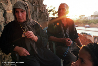 Picture of a Lebanese family sitting outside war-torn ruins.  © 2002, Matthieu Alexandre; part of FreePhotoCourse.com's “Photographer Profiles” series; DO NOT COPY – IP Address recorded - all rights reserved.